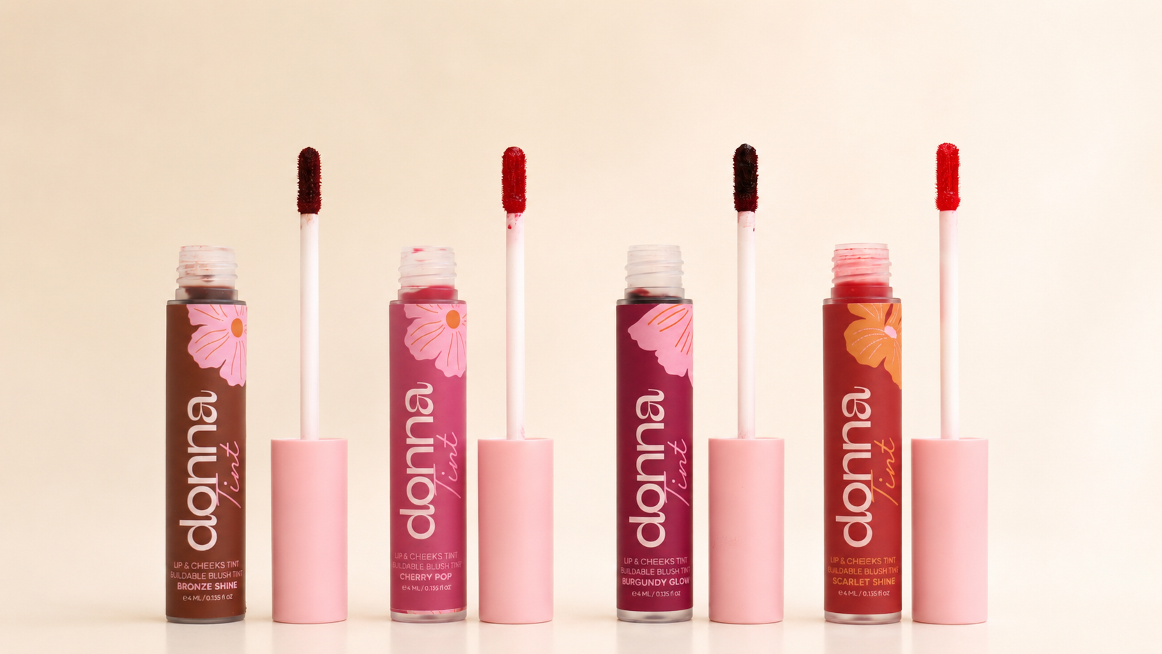 Four open Donna Lip & Cheek Tint shades with their applicators